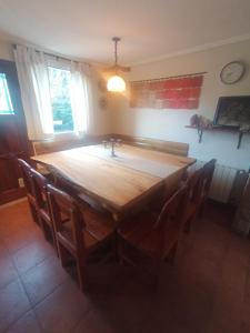 a large wooden table in a room with chairs at Las Asturianas in San Carlos de Bariloche