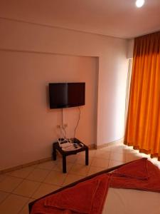 a living room with a flat screen tv on the wall at Saranda porti in Sarandë