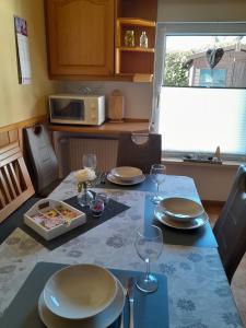 a kitchen with a table with plates and wine glasses at Gerkenhof in Olsberg +19 photos