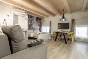 a living room with a couch and a table at La Torre Boutique Apartamentos in Teruel