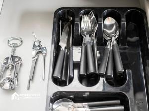 a bunch of utensils sitting on a counter at Comfy 2-Bedroom Family & Contractor Home in Bolton with Free Wi-Fi and Street Parking By North West Accommodation in Bolton +13 photos