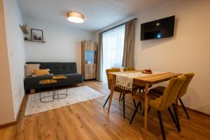 a living room with a table and a couch at Ferienwohnung Tiefengraber in Weiz