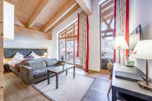 a living room with a couch and a table at Inntaler Hof in Seefeld in Tirol +191 photos