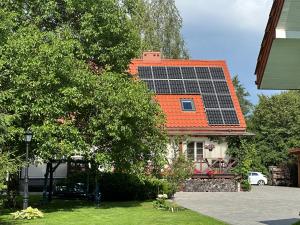 a house with a lot of solar panels on its roof at Raciborówka in Świętajno +30 photos