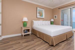 a bedroom with a large bed and a window at Island Royale 1103 in Gulf Shores