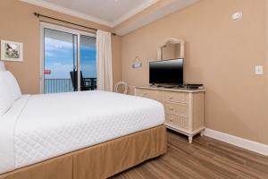 a bedroom with a bed and a flat screen tv at Island Royale 1103 in Gulf Shores +23 photos