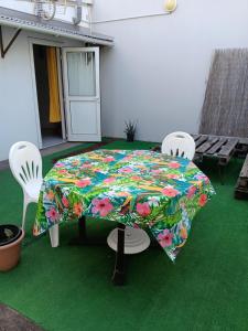 a table with a colorful umbrella on a patio at L'îlot vacances in Saint-Pierre
