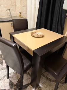 a table with two chairs and a plate on it at GZP Residece Lugoj 22 in Lugoj