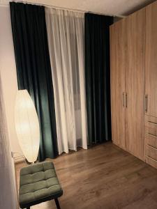 a living room with a chair and a window at GZP Residece Lugoj 22 in Lugoj