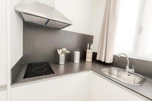 a kitchen with a stove and a sink at La Torre Boutique Apartamentos in Teruel +66 photos