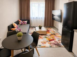 a living room with a couch and a table at Aparthotel Olympland in Trutnov