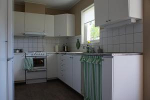 a kitchen with white appliances and a window at Gårdsjö 7 in Gårdsjö +23 photos