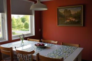 a dining room table with a bowl of fruit on it at Gårdsjö 7 in Gårdsjö