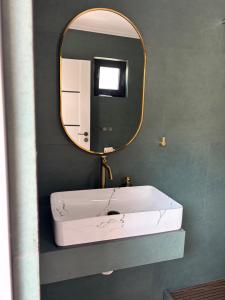 a bathroom with a white sink and a mirror at Geo Saturn in Saturn +20 photos