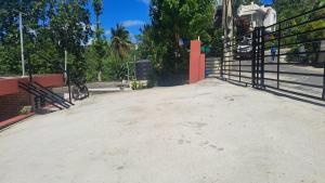 an open gate with a bike parked on the sidewalk at Katty House in Santa Bárbara de Samaná +3 photos