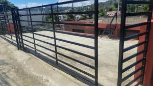 a fence on the side of a building at Katty House in Santa Bárbara de Samaná