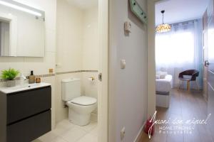 a white bathroom with a toilet and a sink at Casa Alma in Villamediana de Iregua +34 photos