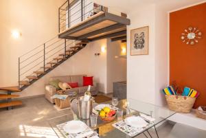 a living room with a glass table and a staircase at Casa Quadrifoglio - Borromeo in Intra +16 photos