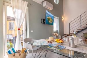 a dining room with a glass table with fruit on it at Casa Quadrifoglio - Borromeo in Intra