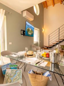 a dining room with a glass table with food on it at Casa Quadrifoglio - Borromeo in Intra