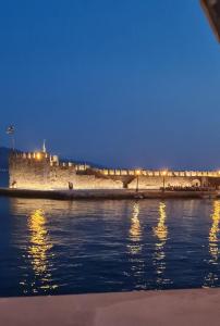 a bridge over the water in front of a castle at View By the Castle Nafpaktos in Nafpaktos +20 photos