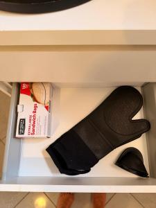 a shelf with a skateboard and a box on it at Palm Beach Vacay Suites - Garden Suite - Poolside in Palm-Eagle Beach