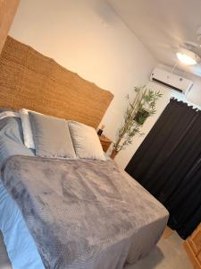 a bedroom with a bed with blue sheets and white pillows at Palm Beach Vacay Suites - Garden Suite - Poolside in Palm-Eagle Beach