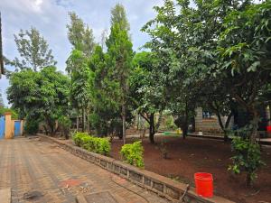 a park with trees and a brick road at Rose Petals in Sagana
