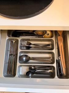 a drawer filled with silver utensils in a cabinet at Palm Beach Vacay Suites - Garden Suite - Poolside in Palm-Eagle Beach