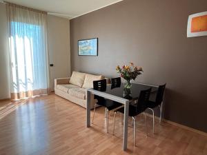 a living room with a table and a couch at Hotel Residence Zodiaco in Modena