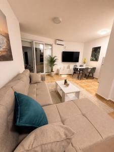 a living room with a couch and a table at Bo Apartment in Bečići