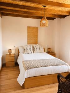 a bedroom with a large bed and a wooden ceiling at RURAL PRADO in San Tirso de Abres