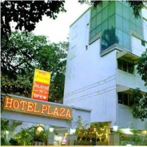 a building with a hotel plaza sign in front of it at Hotel Plaza in Mumbai