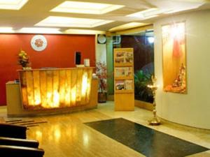 a room with a lobby with a counter and a room with a unintention at Hotel Plaza in Mumbai