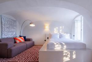 a bedroom with a king sized bed and a couch at stay micro Regensburg in Regensburg