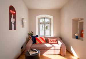 a living room with a couch and a window at stay micro Regensburg in Regensburg
