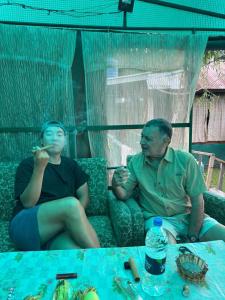a man and a woman sitting on a couch at Green view group of houseboats in Srinagar