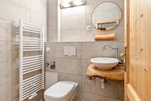 a bathroom with a toilet and a sink and a mirror at Zeitlos Wriezen 1 in Wriezen +11 photos