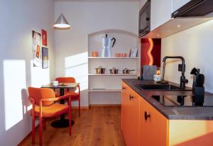 a kitchen with a sink and a counter with a table at stay micro Regensburg in Regensburg