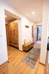 a living room with a couch and wooden floors at Ferienwohnung Tiefengraber in Weiz
