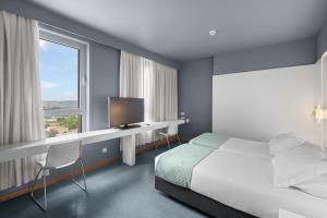 Cama ou camas em um quarto em Basic Braga by Axis mais 36 fotos