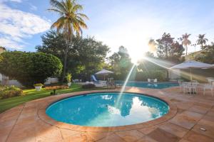 a swimming pool in a yard with a patio at Grande Hotel Águas da Prata in Águas da Prata +48 photos