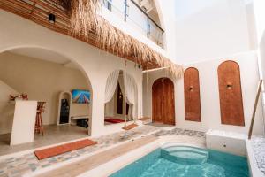 a house with a pool in the middle of a room at Maroko Jogja Villas With Privatepool in Ngaglik