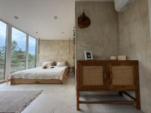 a bedroom with a bed and a large window at Nest Spa Mirror Villas in Medemciems +31 photos