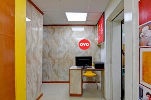 an office with a desk with a computer on a wall at Hotel O Jalan Regency in Kolkata +23 photos