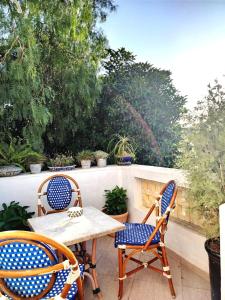 two chairs and a table on a patio at Sainte Madeleine in Boumhel El Bassatine