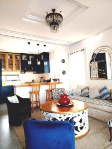 a living room with a couch and a table at Sainte Madeleine in Boumhel El Bassatine