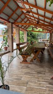 a wooden picnic table under a wooden roof on a patio at Мотель Ріта in Berehove
