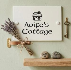 a sign on a wall above a shelf with rocks at Birch Valley Accommodation Tinahely Wicklow in Killicreny Bridge