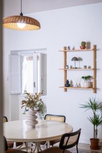 a dining room with a table and chairs at BISCOTTAI Port Apartments in Trapani